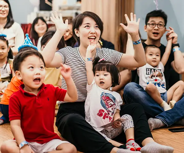 Parent with kids, arms raised