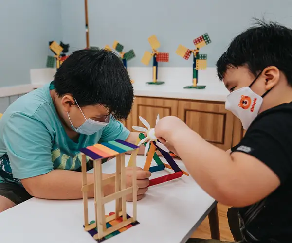 Kids building with ice cream sticks