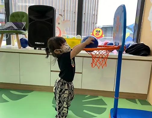 Girl dunking basketball