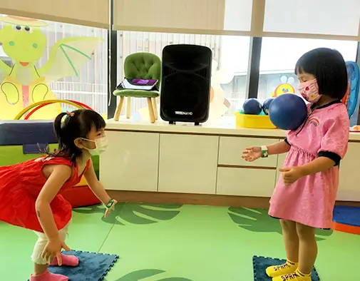 Kids throwing ball to each other