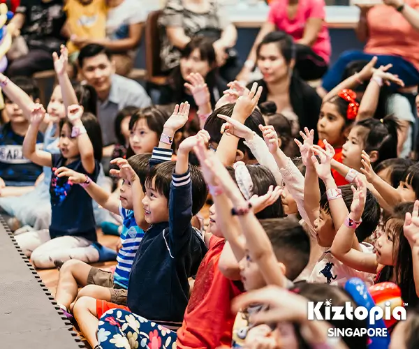 Bunch of kids with raised arms